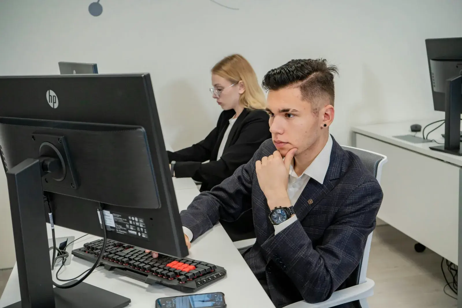 Recruiter and HR partner working through an integration at a laptop